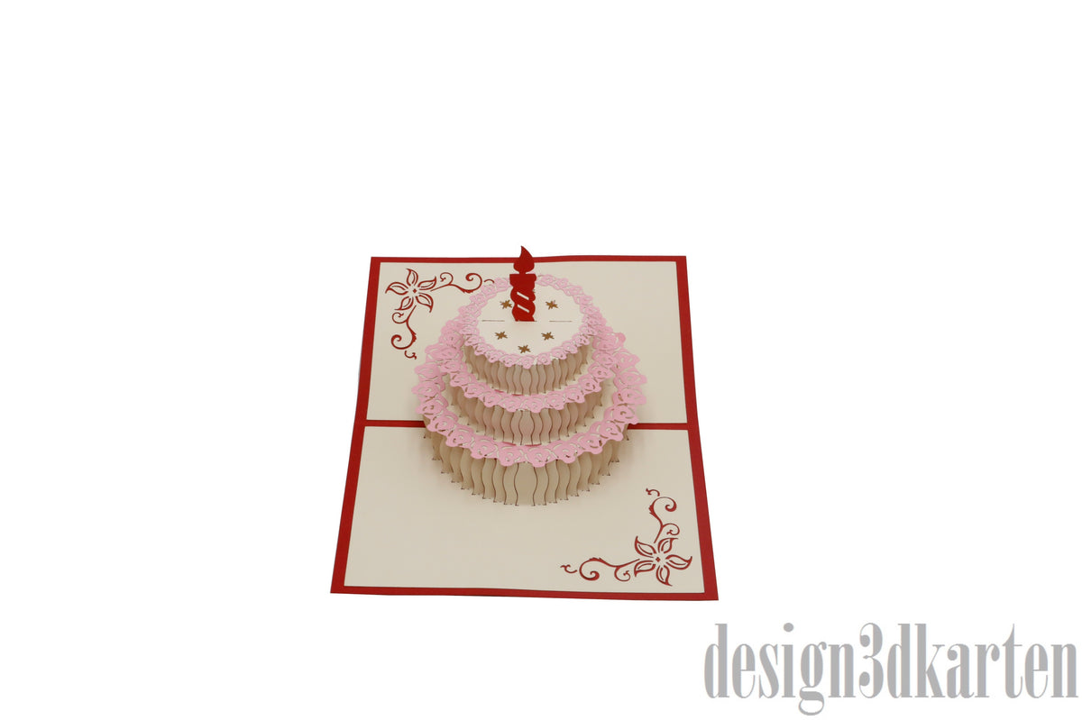 Aufgeklappte Pop-up-Karte mit einer Torte mit roter Kerze und rosa Spitzendekor.