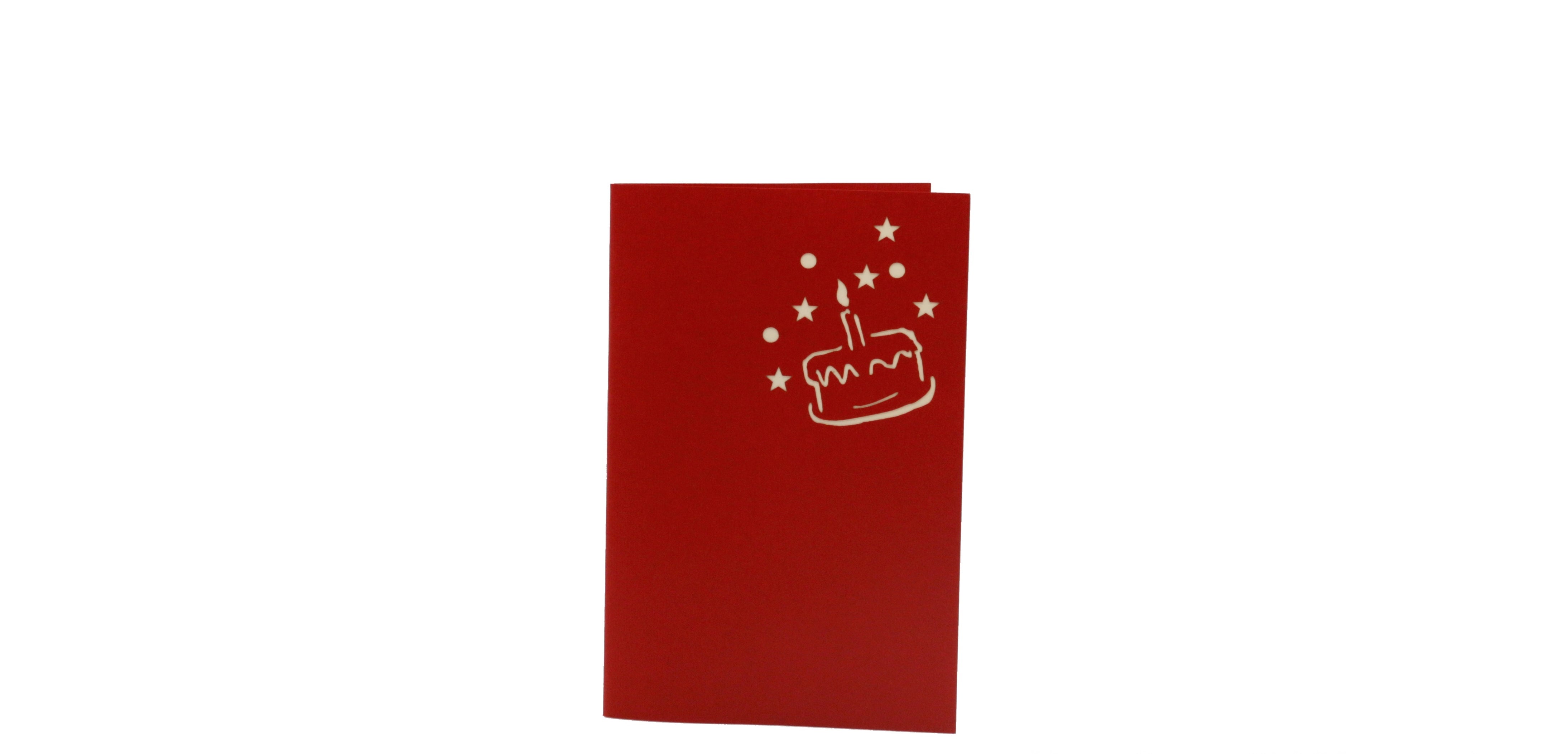 Rote Klappkarte mit einer Torte, Kerze und Sternen im Scherenschnitt auf der Vorderseite.