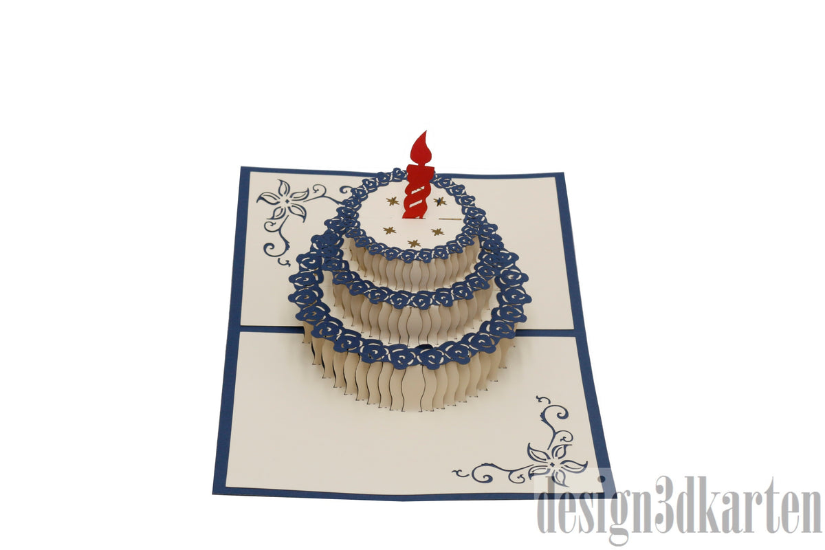 Aufgeklappte Pop-up-Karte mit blauem Rand und einer Torte mit roter Kerze und blauem Spitzendekor.