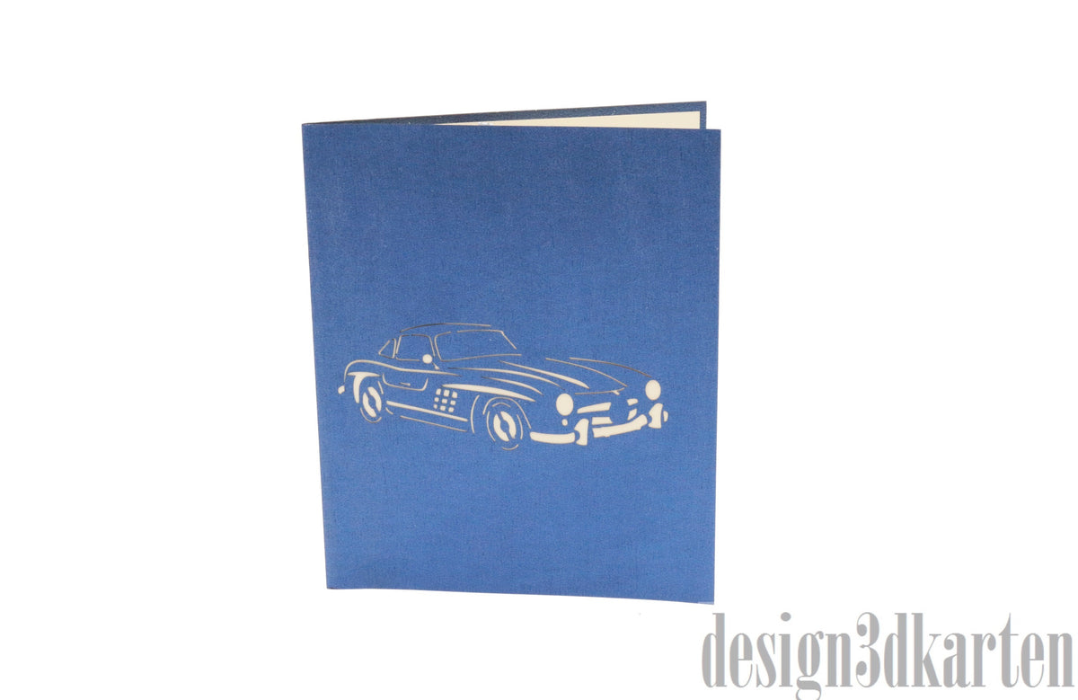 Blaue Kartenvorderseite mit einem Oldtimer-Cabrio als Scherenschnitt.
