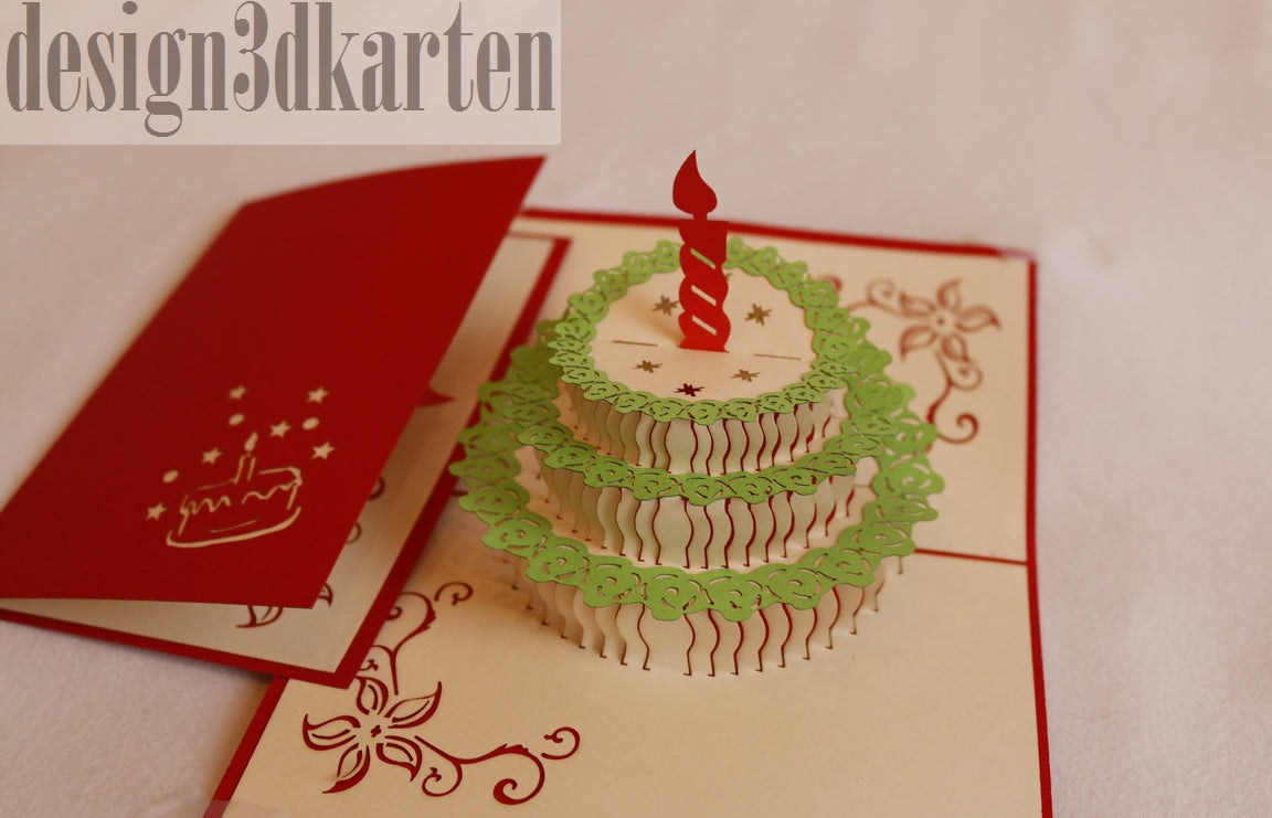 Aufgeklappte Pop-up-Karte mit einer Torte mit grünem Spitzendekor und roter Kerze, daneben die rote Kartenvorderseite.