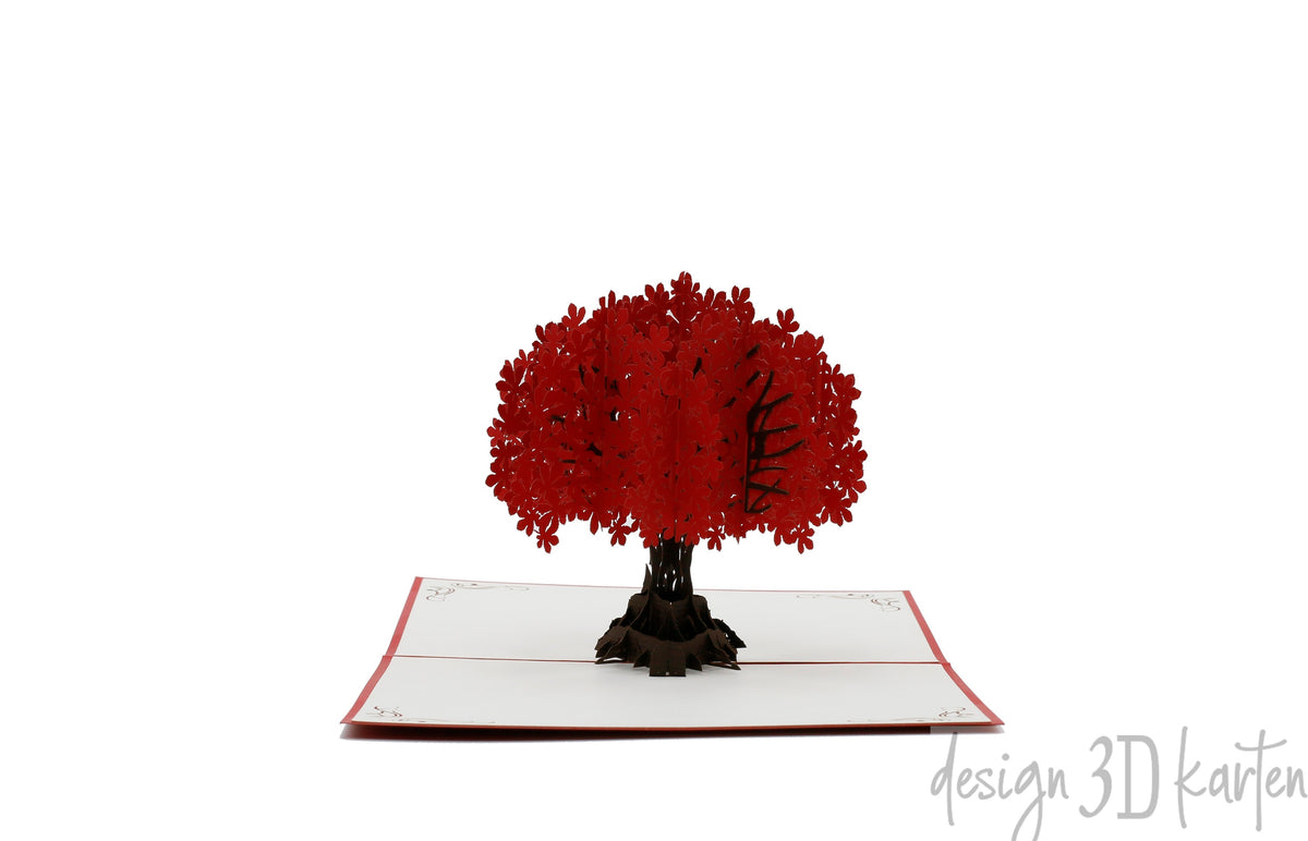 Aufgeklappte Pop-up-Karte mit rotem Rand und einem Baum mit roter Blütenkrone.