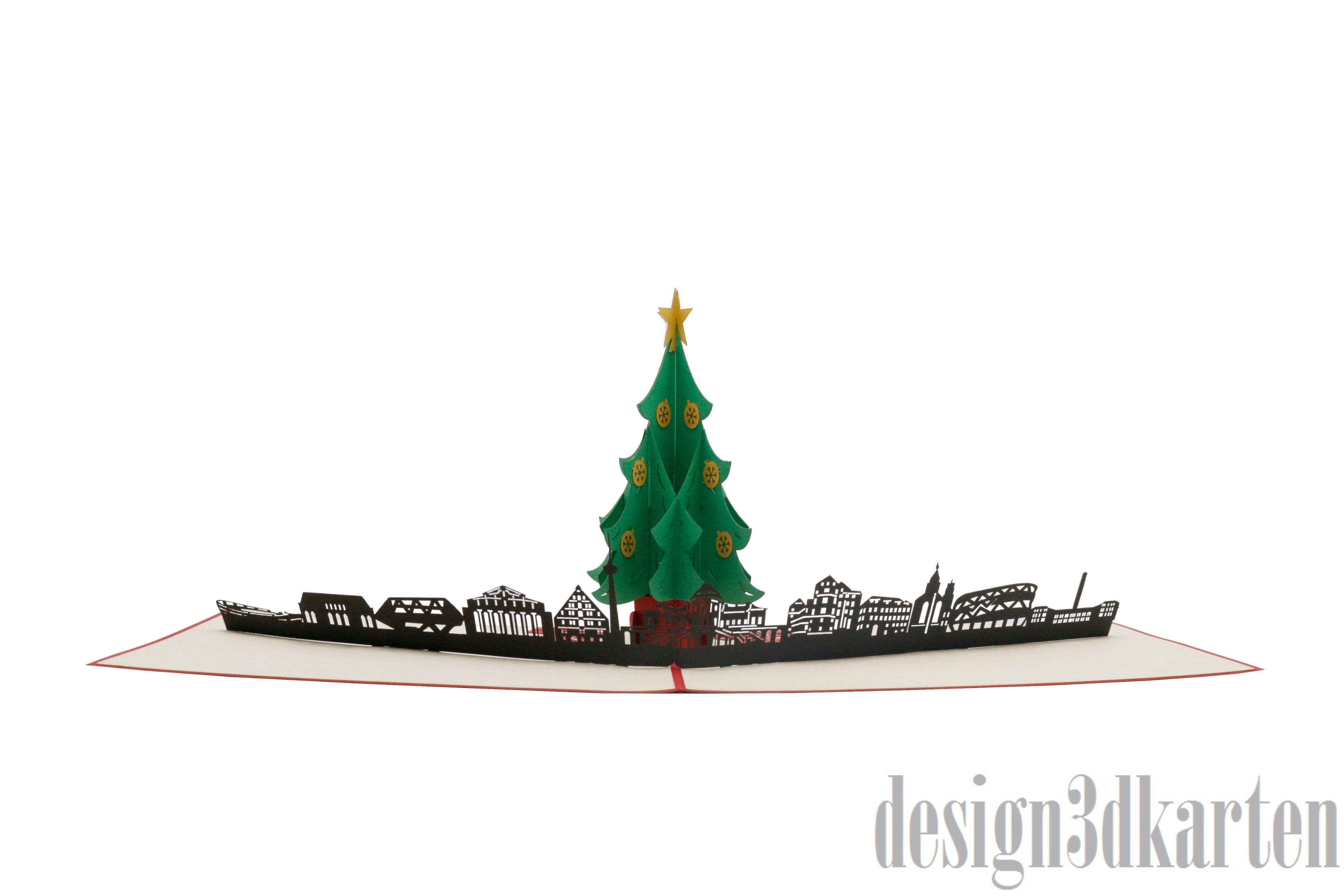 Aufgeklappte Pop-up-Karte mit Weihnachtsbaum vor der Stuttgarter Skyline, seitlich fotografiert.