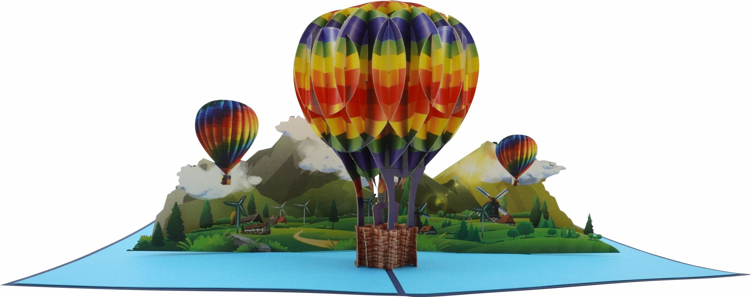Aufgeklappte Pop-up-Karte mit einem bunten Heißluftballon über einer grünen Berglandschaft, seitlich fotografiert.