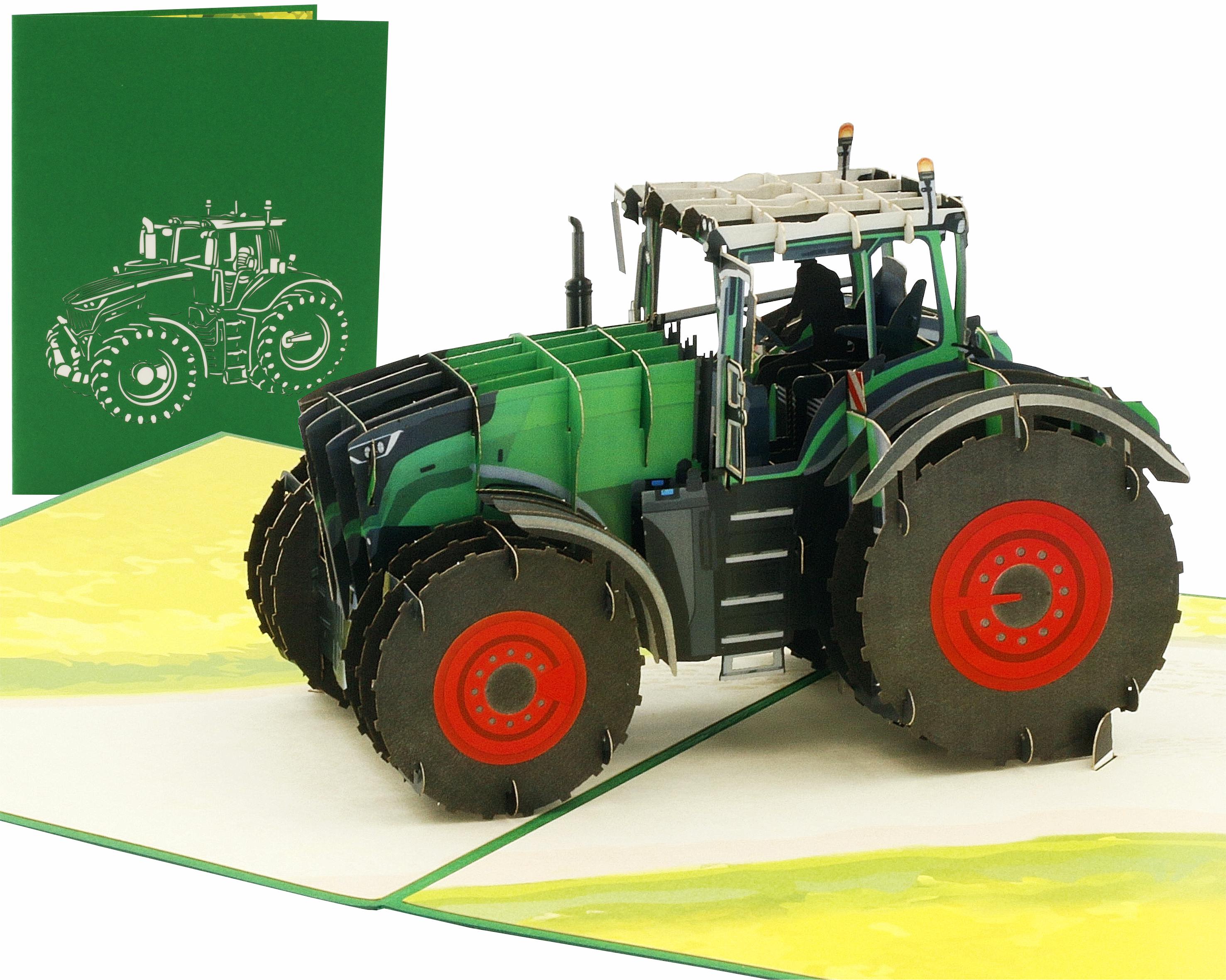 Aufgeklappte Pop-up-Karte mit einem grünen Traktor mit roten Felgen auf einem Feld, dahinter die grüne Kartenvorderseite mit Traktor-Scherenschnitt.