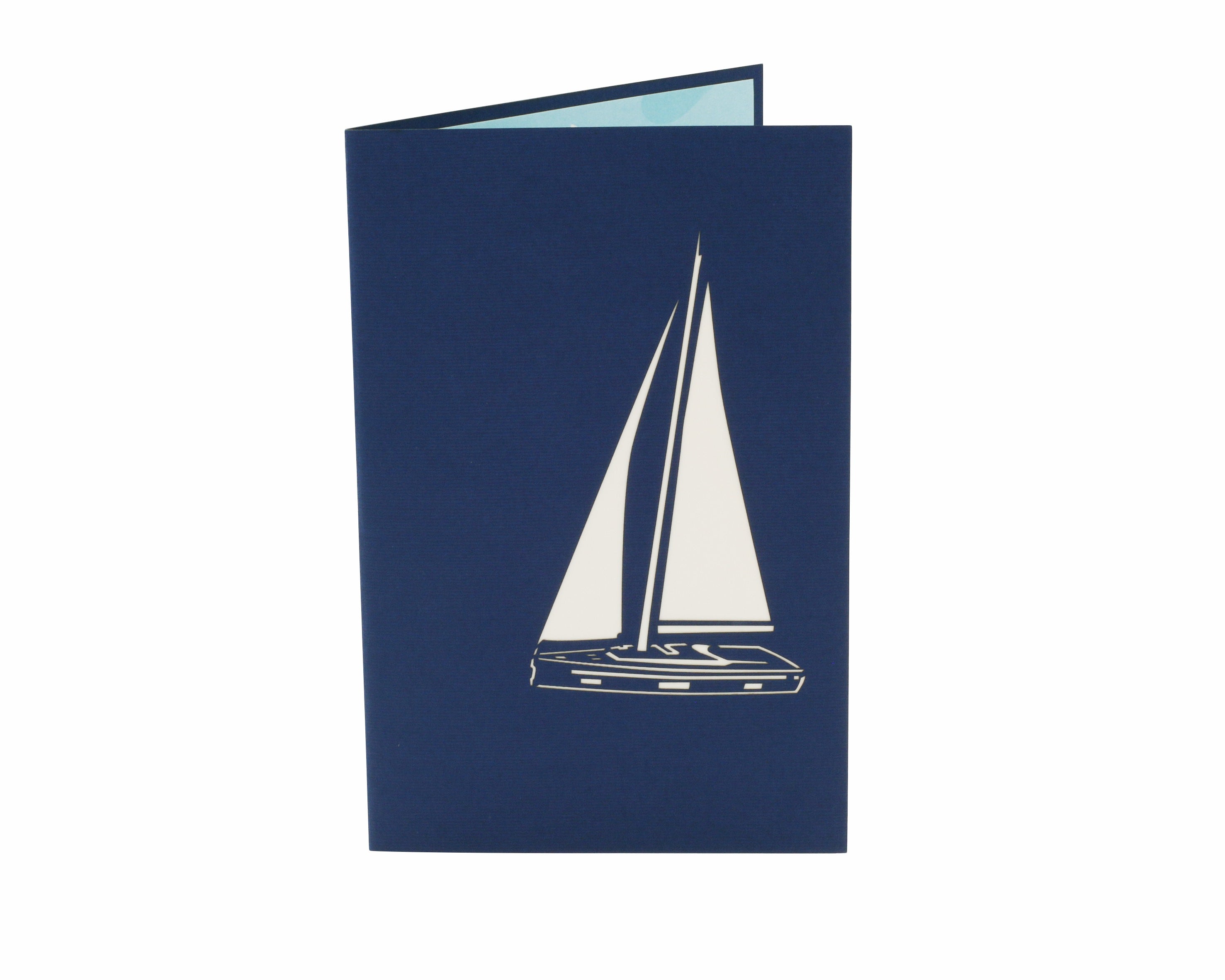 Klappkarte in blau mit einem Segelboot als Scherenschnitt.