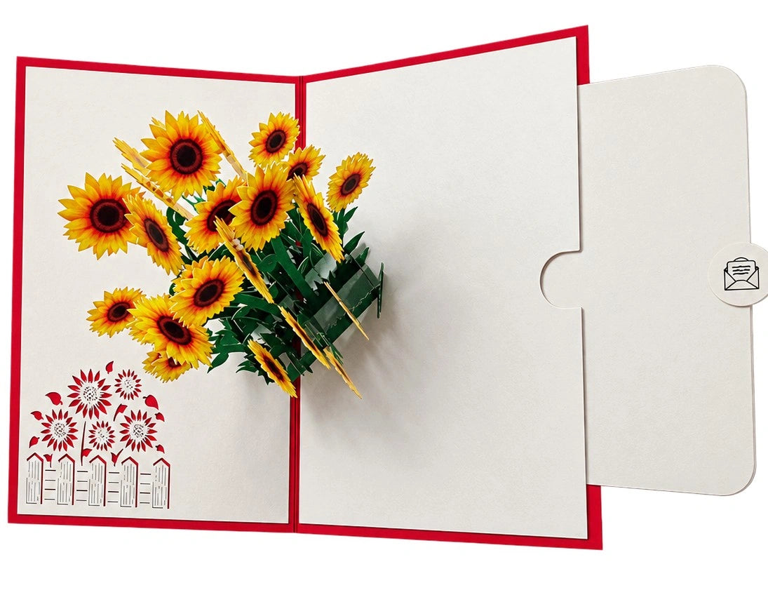 Aufgeklappte Pop-up-Karte mit rotem Rand und einem Strauß gelber Sonnenblumen. Auf der rechten Seite ein Einschub zum Beschriften.