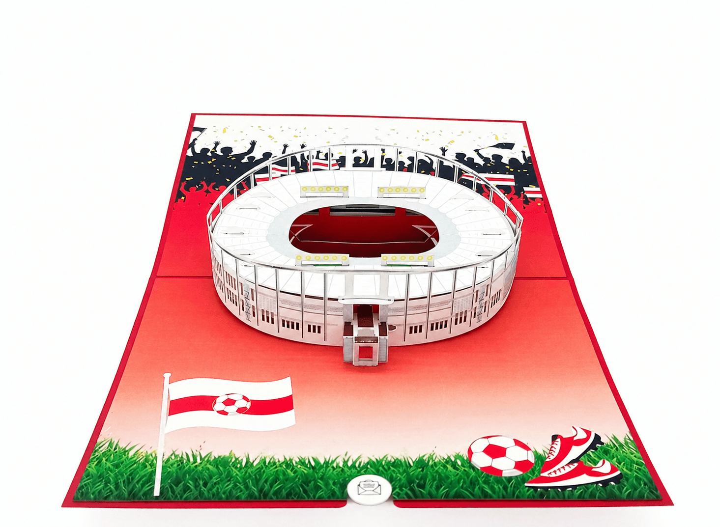 Aufgeklappte Pop-up-Karte mit dem Stuttgarter Stadion, Fahne, Fußball und Fußballschuhen auf grünem Rasen.