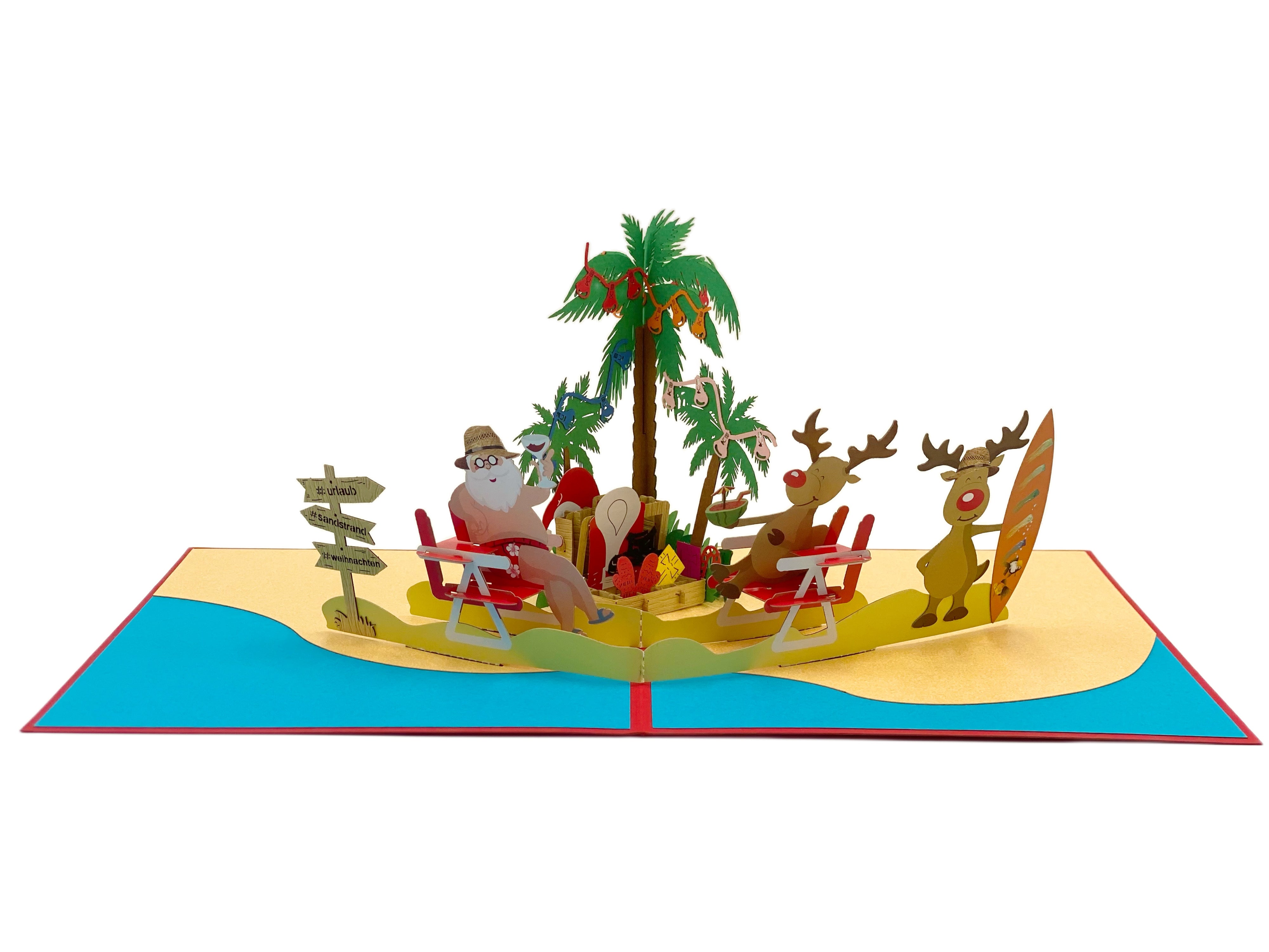 Aufgeklappte Pop-up-Karte mit Weihnachtsmann und Rentieren am Strand, Palmen mit Christbaumkugeln, gelbem Sand und türkisem Meer.