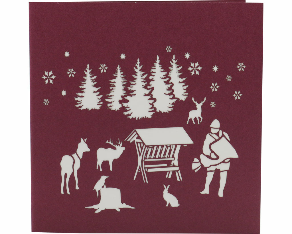 Klappkarte futterkrippe im wald mit jäger und tieren