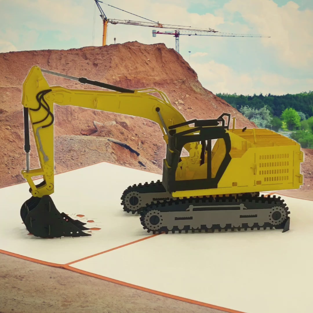 Video: Aufgeklappte Pop-up-Karte mit gelbem Bagger auf einer Baustelle mit Kränen im Hintergrund.