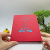 Video: Die rote Kartenvorderseite mit dem Schriftzug Fröhliche Weihnachten und blauem Weihnachtsbaum wird in den Händen aufgeklappt.