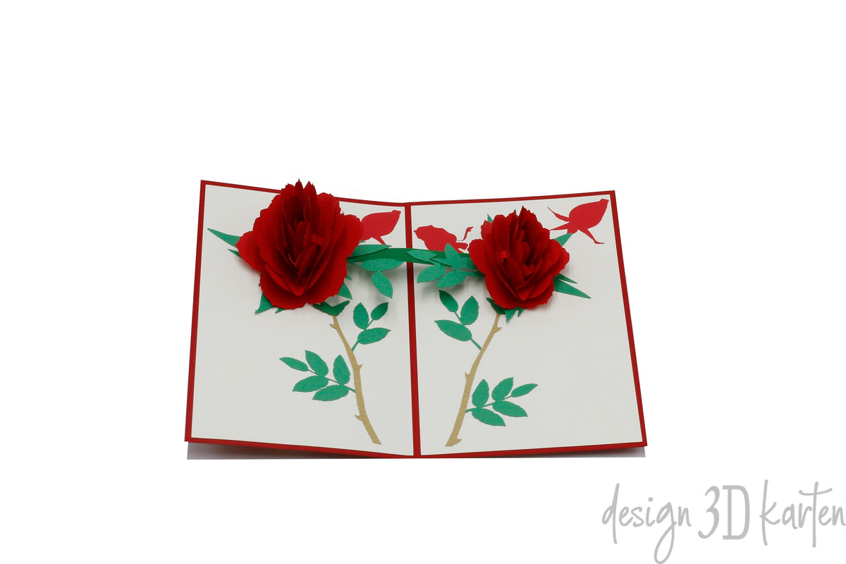 Aufgeklappte Pop-up-Karte mit rotem Rand und zwei roten Rosen mit grünen Blättern.