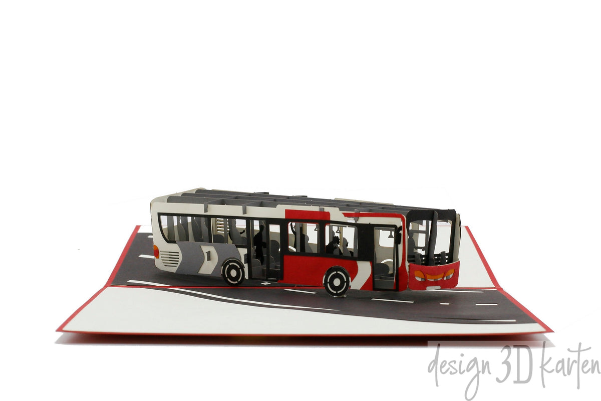 Aufgeklappte Pop-up-Karte mit rotem Rand und einem rot-weißen Gelenkbus auf einer Straße.