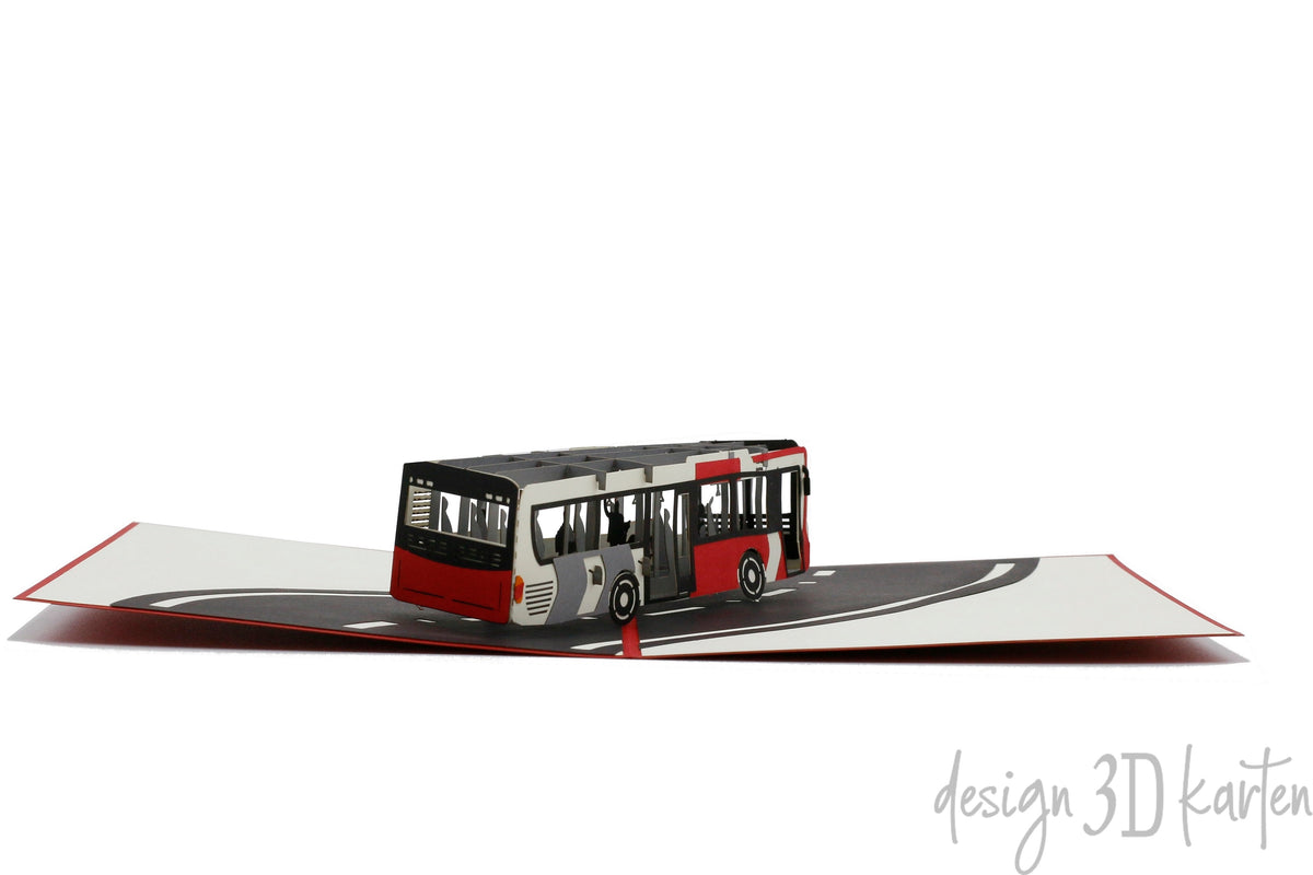 Aufgeklappte Pop-up-Karte mit einem Bus, flach von vorne fotografiert.