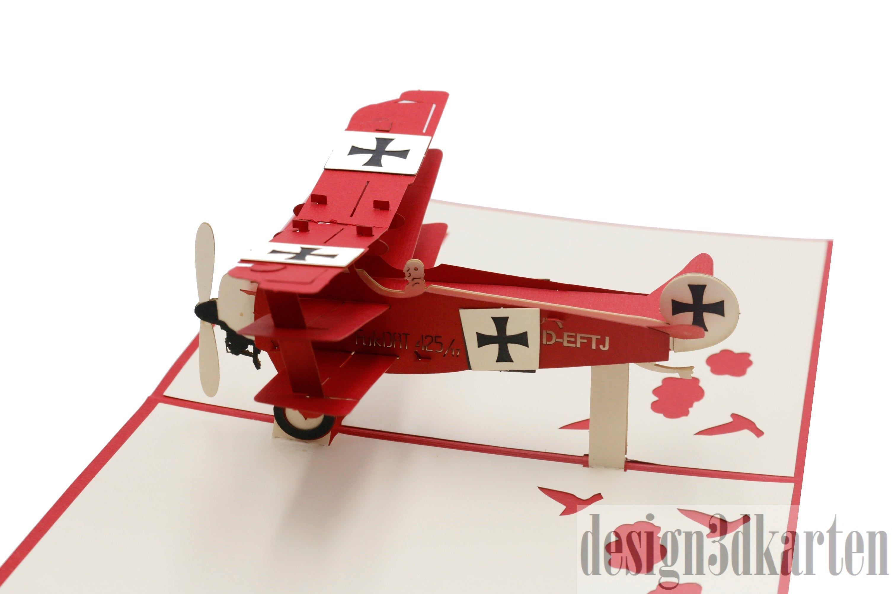 Nahaufnahme der aufgeklappten Pop-up-Karte mit einem roten Dreidecker mit Propeller und Eisernen Kreuzen.