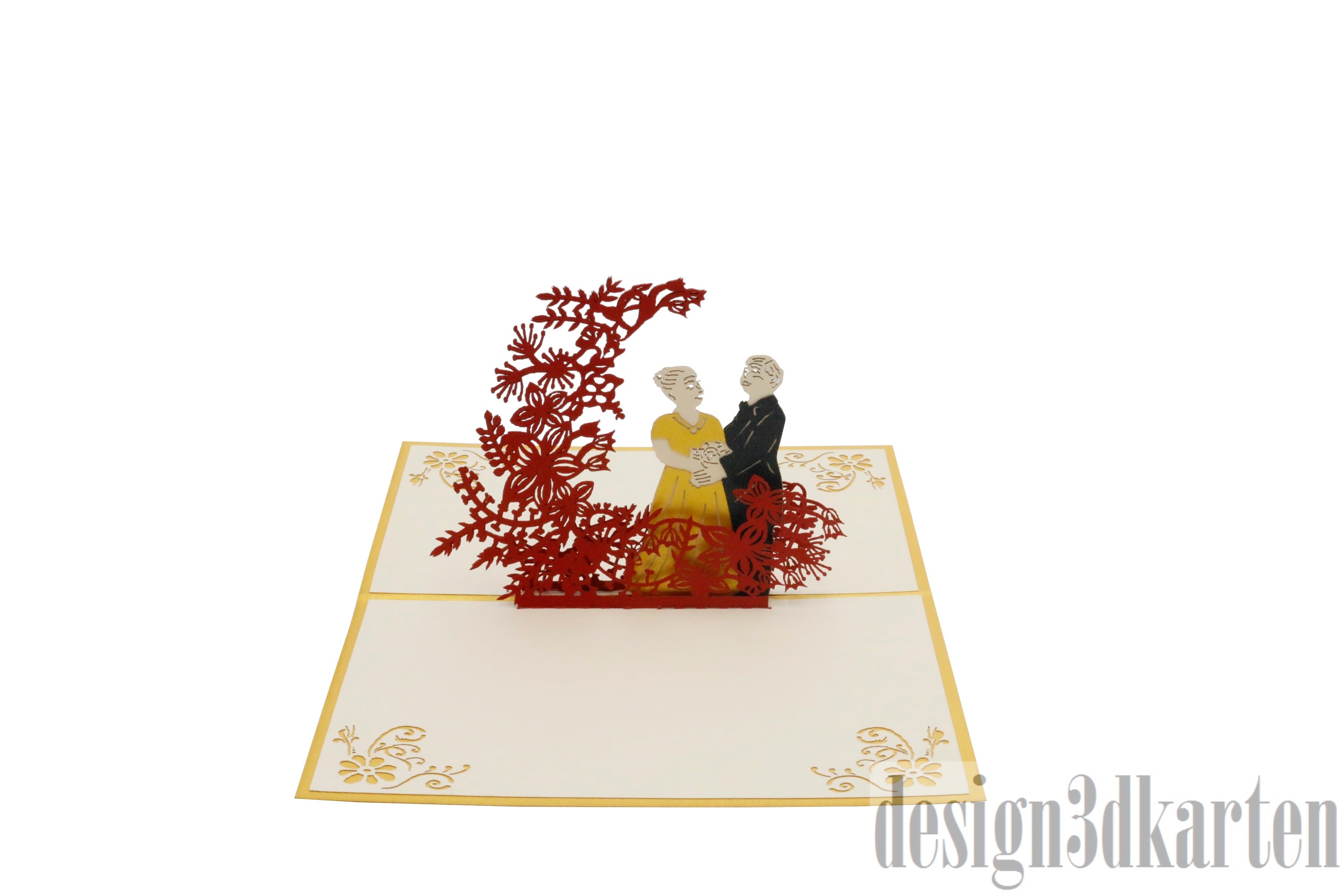 Aufgeklappte Pop-up-Karte mit goldenem Rand: ein Hochzeitspaar steht vor einem roten Blütenbaum.