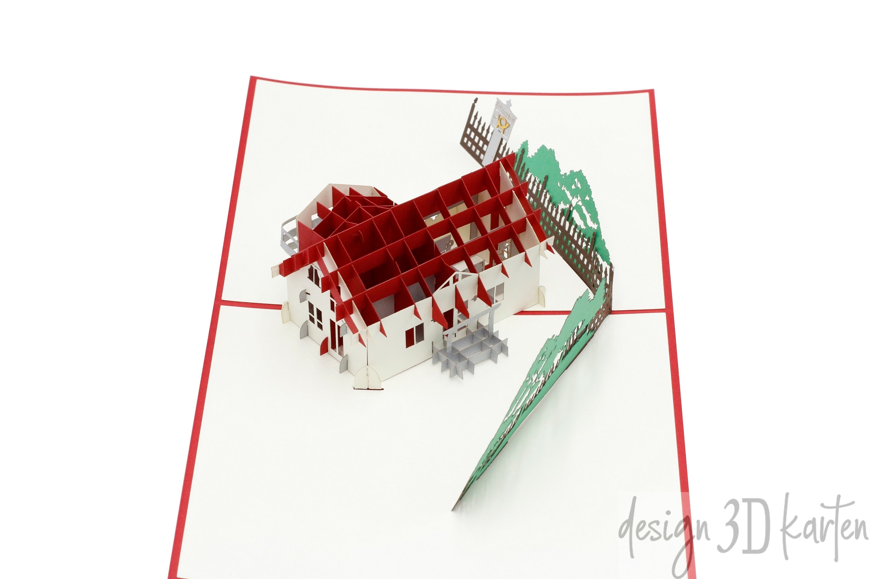 Nahaufnahme der aufgeklappten Pop-up-Karte mit einem Wohnhaus aus Papier.