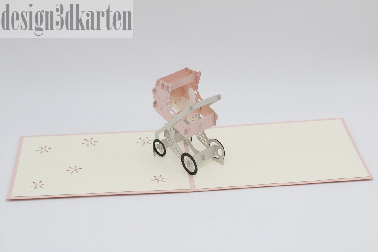 Aufgeklappte Pop-up-Karte mit rosa Rand und einem rosa Kinderwagen aus Papier.