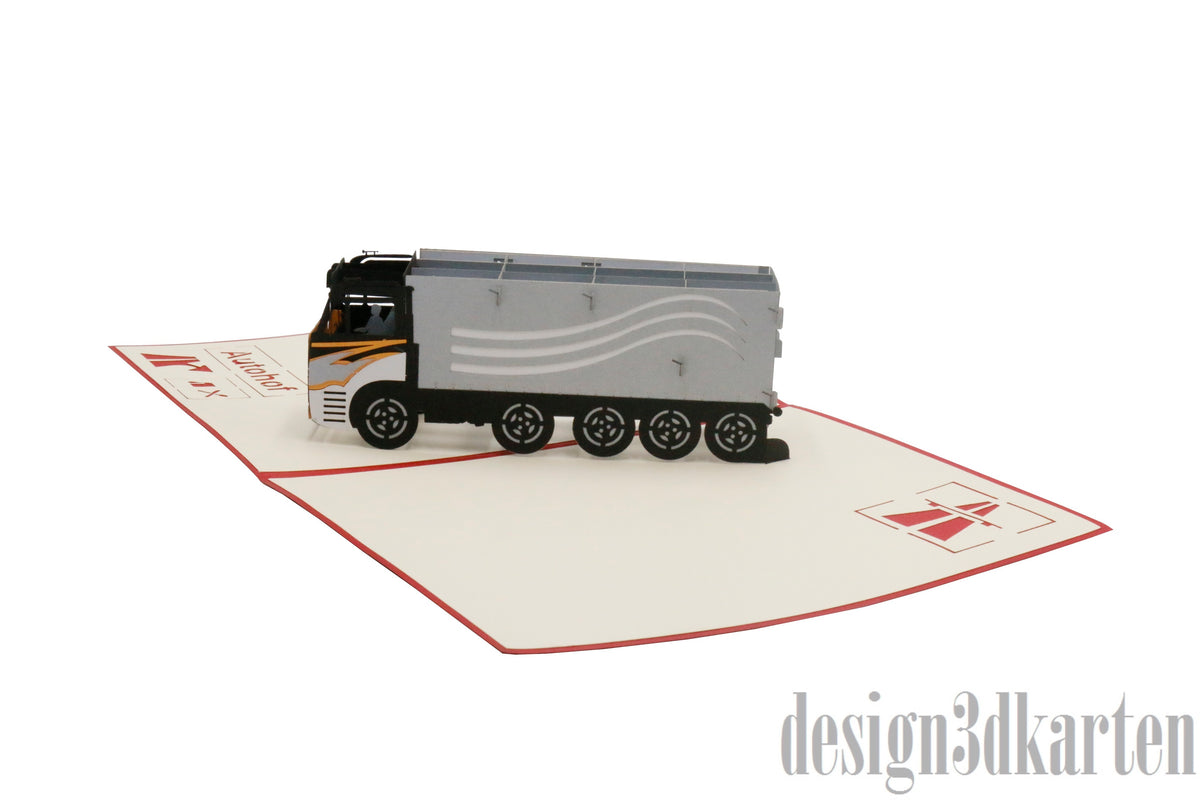 Aufgeklappte Pop-up-Karte mit einem detailreichen LKW aus Papier, schräg von der Seite fotografiert.
