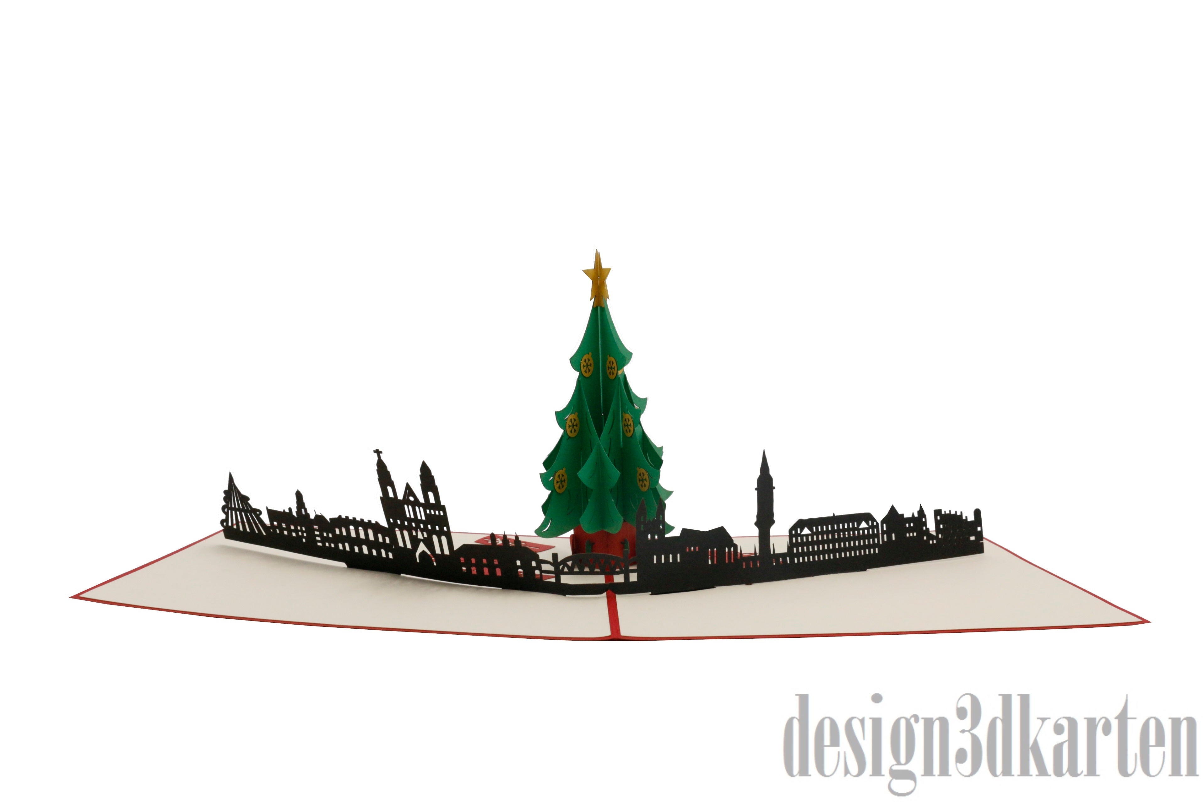 Aufgeklappte Pop-up-Karte mit Weihnachtsbaum vor der Magdeburger Skyline, seitlich fotografiert.