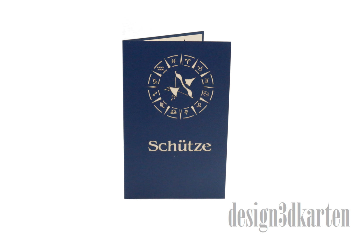 Dunkelblaue Kartenvorderseite mit Tierkreiszeichen und dem Schriftzug Schütze als Scherenschnitt.
