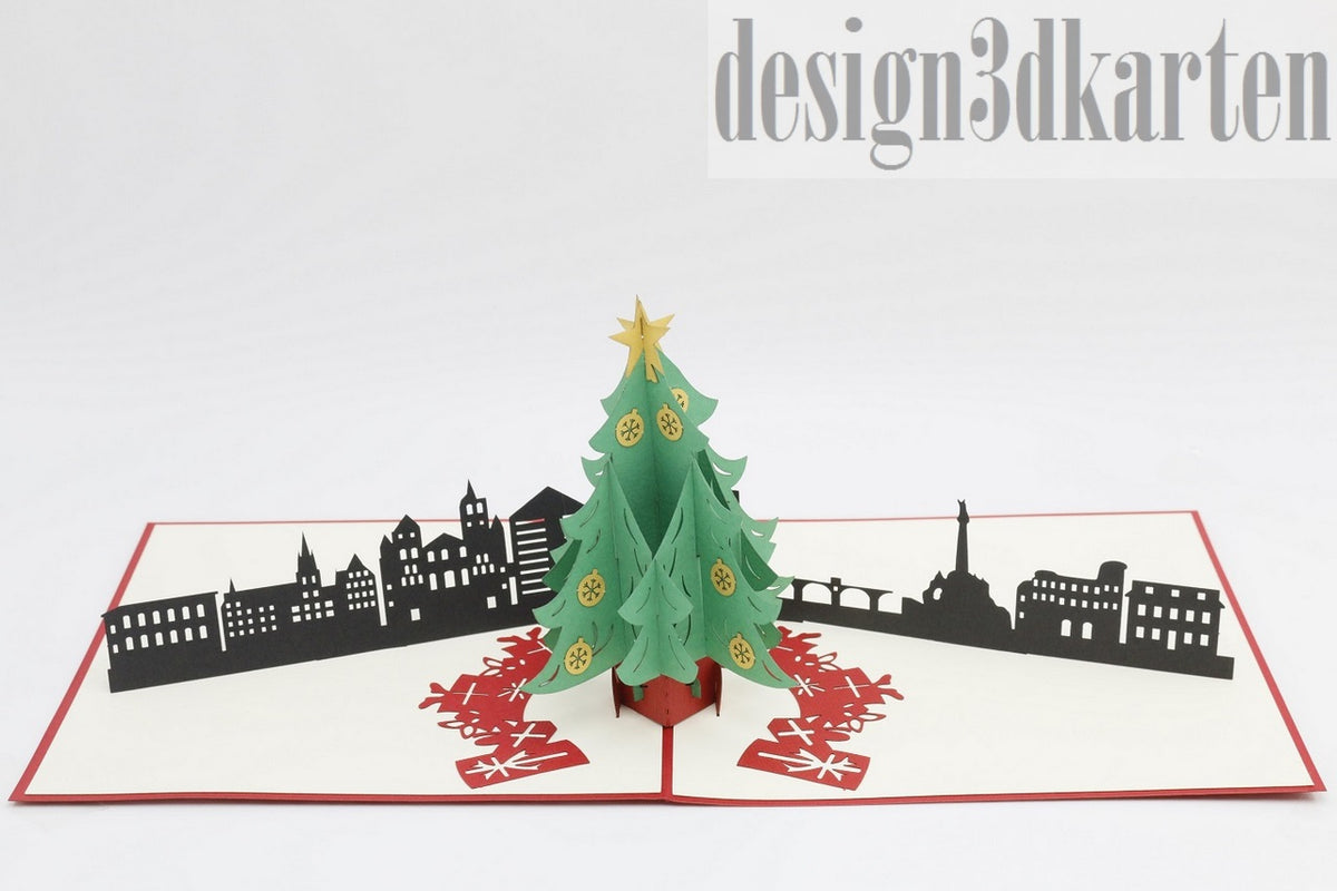 Aufgeklappte Pop-up-Karte mit grünem Weihnachtsbaum vor der schwarzen Skyline von Trier.