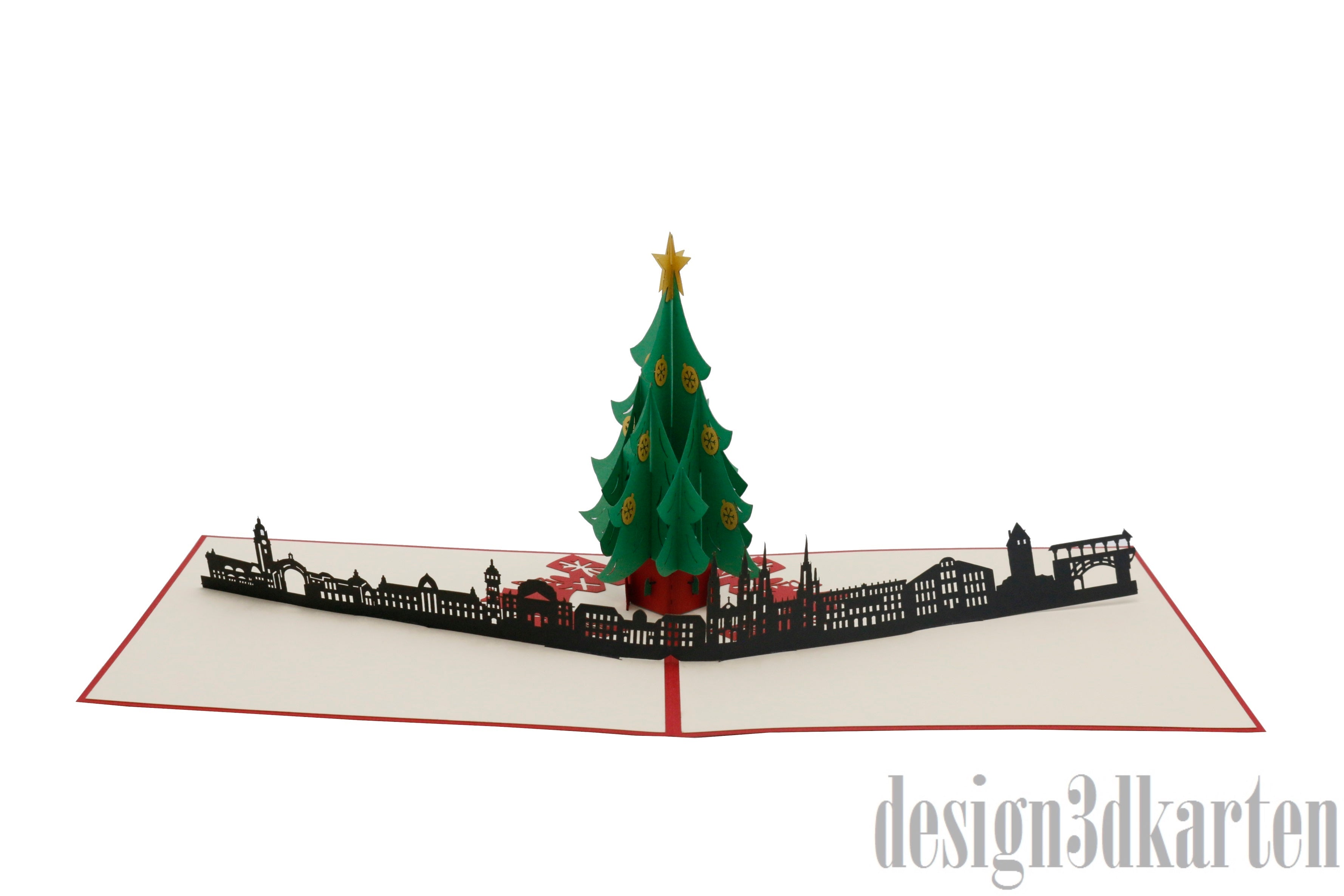 Aufgeklappte Pop-up-Karte mit Weihnachtsbaum vor der Wiesbadener Skyline, schräg von der Seite fotografiert.