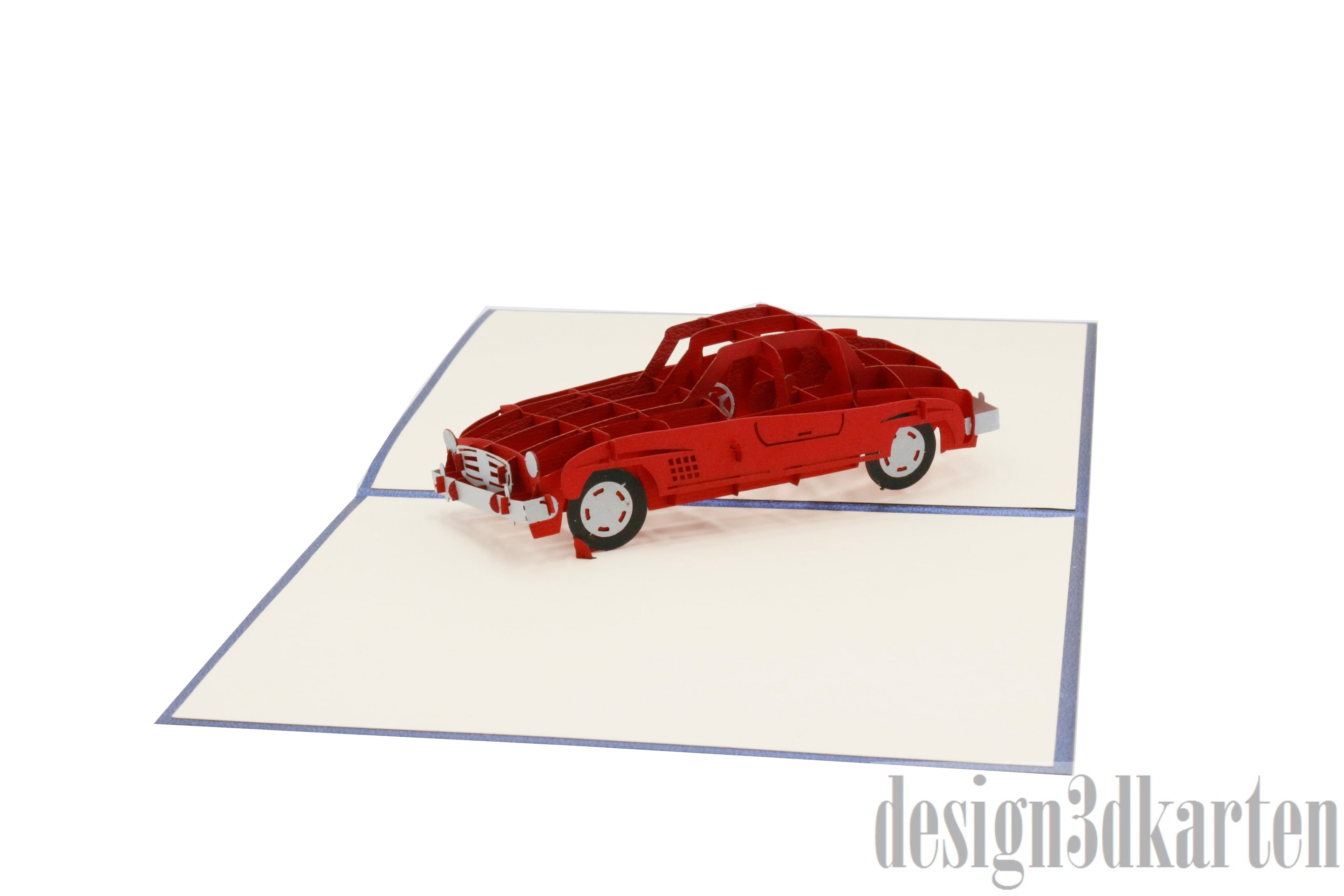 Aufgeklappte Pop-up-Karte mit blauem Rand und einem roten Oldtimer-Cabrio aus Papier.